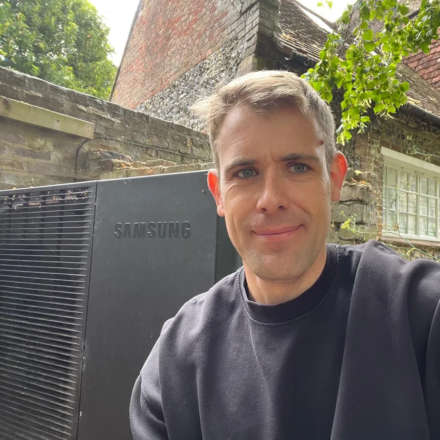 Henry, SmartClimate co-founder, next to a Samsung heat pump installation