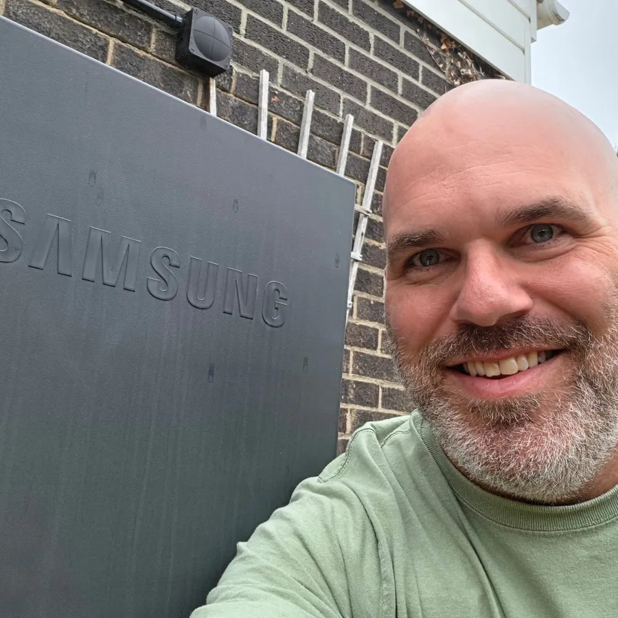 Jez, SmartClimate co-founder, next to a Samsung heat pump installation